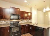 Thumbnail 2 of 14 - Elegant And Timeless Kitchen at 7th Street Brownstones, Indigo Living, IA