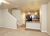 Thumbnail 4 of 14 - Spacious carpeted Living Room at 7th Street Brownstones, Indigo Living