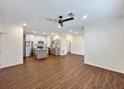 Thumbnail 8 of 51 - an empty living room with a kitchen and a ceiling fan at 92West, Iowa  