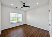 Thumbnail 10 of 51 - an empty living room with a ceiling fan and a window at 92West, Iowa, 50266