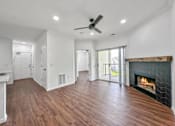 Thumbnail 9 of 51 - a living room with a fireplace and wooden floors at 92West, West Des Moines, 50266  