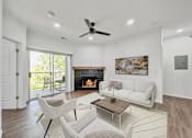 Thumbnail 6 of 51 - a living room with couches and chairs and a fireplace at 92West, West Des Moines  