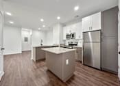 Thumbnail 14 of 51 - a kitchen with stainless steel appliances and white cabinets at 92West, West Des Moines, IA  