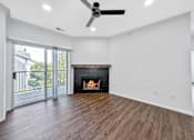 Thumbnail 12 of 51 - an empty living room with a fireplace and a sliding glass door at 92West, West Des Moines Iowa  
