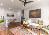 Thumbnail 1 of 60 - A living room with a couch, chairs, and a coffee table.