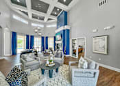 Thumbnail 15 of 51 - a living room with blue curtains and a white coffered ceiling at 92West, West Des Moines Iowa  