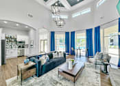 Thumbnail 21 of 51 - a living room with a blue couch and a coffee table at 92West, West Des Moines  