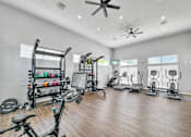 Thumbnail 38 of 51 - a home gym with exercise machines and a ceiling fan at 92West, Iowa  