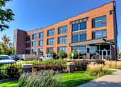Thumbnail 21 of 23 - Community Exterior and Green Walkways at Ballyard Lofts, Indigo Living, IA