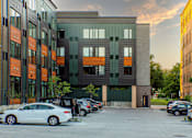 Thumbnail 26 of 27 - a city street with cars parked in front of a building at Canary Lofts, Des Moines, 50311