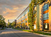 Thumbnail 23 of 27 - a city street with a brick building and a church in the distance at Canary Lofts, Des Moines, 50311