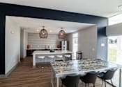 Thumbnail 17 of 23 - a dining room and kitchen with a marble table and chairs at Centennial Crossing, Iowa, 50263