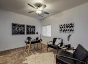 Thumbnail 4 of 23 - a living room with two black chairs and a ceiling fan at Centennial Crossing, Waukee, 50263