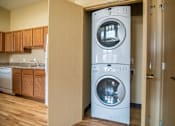 Thumbnail 8 of 16 - A white washing machine and dryer in a home laundry room.at Cottages at Johnston Commons, Johnston, IA 50131  