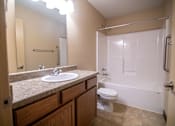 Thumbnail 11 of 16 - A bathroom with a sink, toilet, and bathtub.at Cottages at Johnston Commons, Iowa  