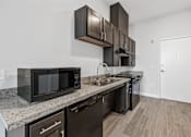 Thumbnail 14 of 52 - A kitchen with black appliances and brown cabinets.