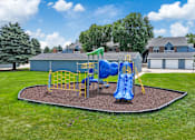 Thumbnail 18 of 53 - A playground with a blue slide and yellow safety barriers.