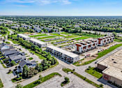 Thumbnail 10 of 36 - A large aerial view of a residential area with multiple houses and apartment buildings.