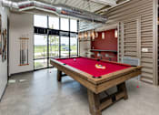 Thumbnail 4 of 42 - A pool table in a room with a view of the outside. at Eagle View Lofts, Des Moines