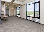 Thumbnail 35 of 42 - A large room with a table and chairs and a view of the outside. at Eagle View Lofts, Des Moines, Iowa