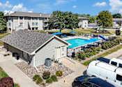 Thumbnail 66 of 74 - A swimming pool is surrounded by a fence and a building.