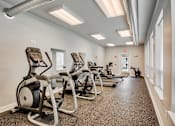 Thumbnail 17 of 31 - A gym with treadmills and exercise equipment.
