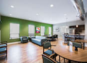 Thumbnail 20 of 31 - A room with a green wall and a wooden floor.