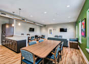 Thumbnail 11 of 31 - A conference room with a long table and chairs.