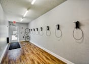 Thumbnail 15 of 31 - A hallway with a bicycle and a door with an exit sign.