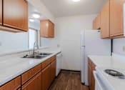 Thumbnail 17 of 66 - A kitchen with white appliances and wooden cabinets.