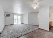 Thumbnail 3 of 66 - A spacious room with a ceiling fan and a window with blinds.