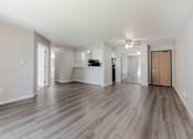 Thumbnail 1 of 66 - A spacious room with wooden flooring and a ceiling fan.