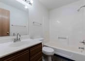 Thumbnail 16 of 66 - A white bathroom with a toilet, sink, and bathtub.