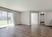 Thumbnail 4 of 66 - A room with wooden flooring and white walls.