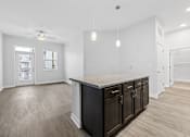 Thumbnail 3 of 52 - A kitchen with a counter and cabinets.