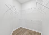Thumbnail 44 of 52 - Empty room with white walls and wooden floor.