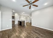 Thumbnail 21 of 32 - A spacious room with a ceiling fan and wooden flooring at The Barclay Apartments, Altoona, 50009