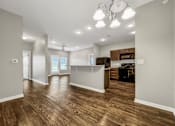 Thumbnail 25 of 32 - A spacious kitchen and living room with wood flooring and modern appliances. at The Barclay Apartments, IOWA, 50009