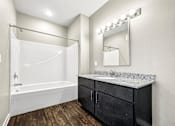 Thumbnail 28 of 32 - a bathroom with a sink and a shower and a mirror at The Barclay Apartments, Altoona, 50009