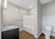 Thumbnail 29 of 32 - a bathroom with a toilet and a shower and a sink at The Barclay Apartments, Altoona, IOWA