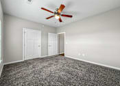 Thumbnail 16 of 32 - an empty room with carpet and a ceiling fan at The Barclay Apartments, Altoona