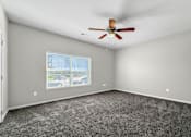 Thumbnail 17 of 32 - A room with a ceiling fan and a window with blinds. at The Barclay Apartments, IOWA