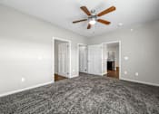 Thumbnail 20 of 32 - a spacious living room with carpet and a ceiling fan at The Barclay Apartments, Altoona, IA