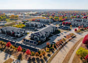 Thumbnail 47 of 50 - A large building surrounded by trees with autumn leaves. at Stonegate Crossing Apartments, IOWA