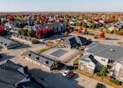 Thumbnail 40 of 50 - A bird's eye view of a residential area with houses and cars. at Stonegate Crossing Apartments, Clive, 50325