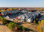 Thumbnail 44 of 50 - A bird's eye view of a residential area with houses and trees at Stonegate Crossing Apartments, Clive, IOWA