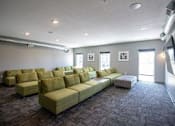 Thumbnail 22 of 34 - A living room with a long sofa and a patterned carpet.at Linc, Des Moines, IA  