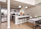 Thumbnail 5 of 34 - A modern kitchen with a refrigerator, stove, and bar area.at Linc, Iowa, 50309