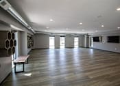 Thumbnail 29 of 34 - A room with wooden floors and a bench.at Linc, Des Moines Iowa   