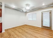 Thumbnail 21 of 35 - A room with wooden flooring and a ceiling fan at Melbourne Apartments, Iowa, 50320